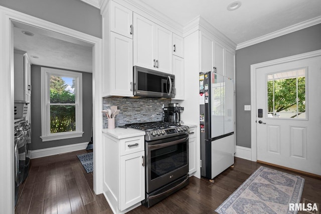 1309 5th St, Orion, IL 61273 - kitchen featuring stainless steel appliances, decorative backsplash, white cabinets, dark wood-style floors, and plenty of natural light