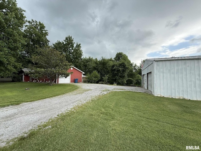 501 N Cambridge Dr, Desoto, IL 62924 - view of green lawn featuring an outbuilding, driveway, and a garage