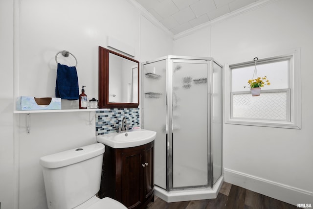 1207 N Marquette St, Davenport, IA 52804 - full bath featuring crown molding, vanity, a shower stall, wood finished floors, and tasteful backsplash