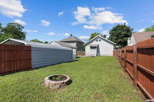 1207 N Marquette St, Davenport, IA 52804 - fenced backyard featuring a fire pit and an outdoor structure