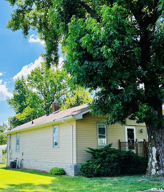 104 S 8th St, Herrin, IL 62948 - view of home's exterior featuring a yard and a chimney