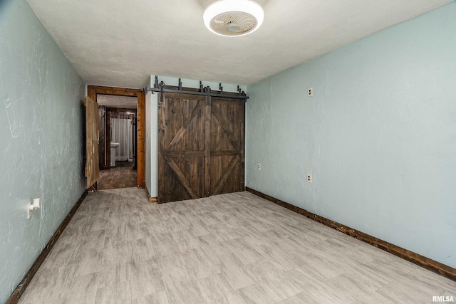 1904 E D St, West Frankfort, IL 62896 - unfurnished bedroom with baseboards and a barn door