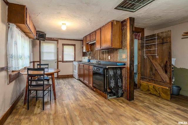 1904 E D St, West Frankfort, IL 62896 - kitchen with white stove, wood finished floors, brown cabinets, black dishwasher, and a textured ceiling