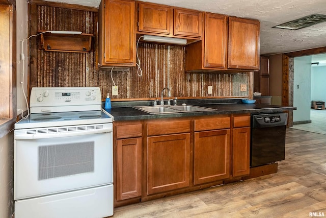 1904 E D St, West Frankfort, IL 62896 - kitchen with white electric stove, dishwasher, light wood-style floors, and brown cabinets