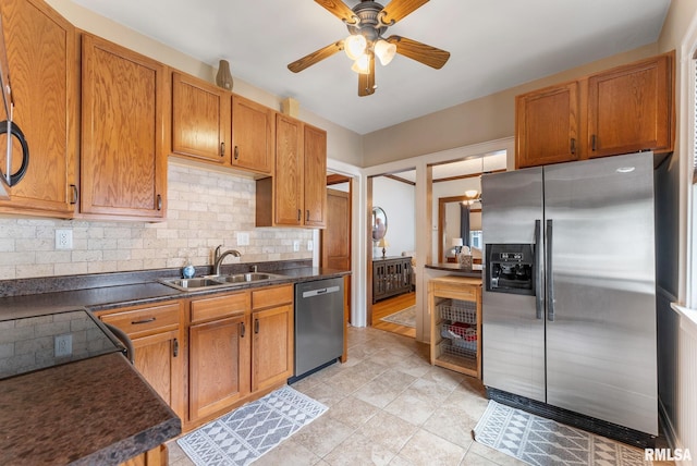 517 E 29th Pl, Davenport, IA 52803 - kitchen with stainless steel appliances, dark countertops, ceiling fan, and backsplash