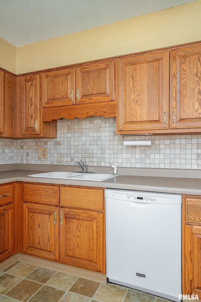 4718 19th Ave, Moline, IL 61265 - kitchen featuring dishwasher, brown cabinetry, tasteful backsplash, and a textured ceiling