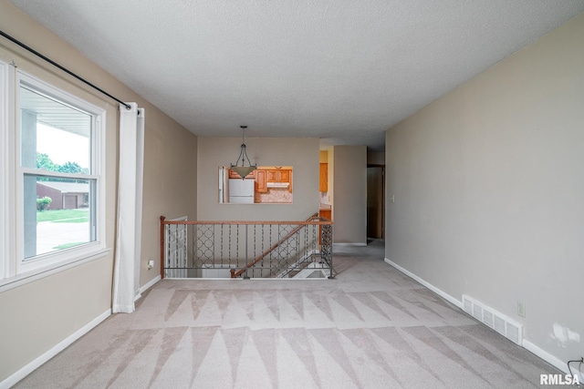 4718 19th Ave, Moline, IL 61265 - empty room featuring carpet and a textured ceiling