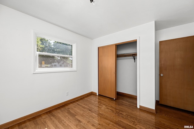 2525 4th St Unit A, East Moline, IL 61244 - unfurnished bedroom featuring wood finished floors and a closet