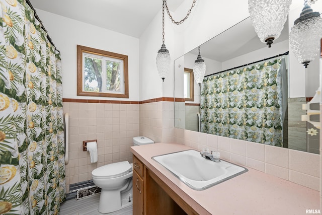 2525 4th St Unit A, East Moline, IL 61244 - full bath with tile walls, plenty of natural light, vanity, wainscoting, and a chandelier