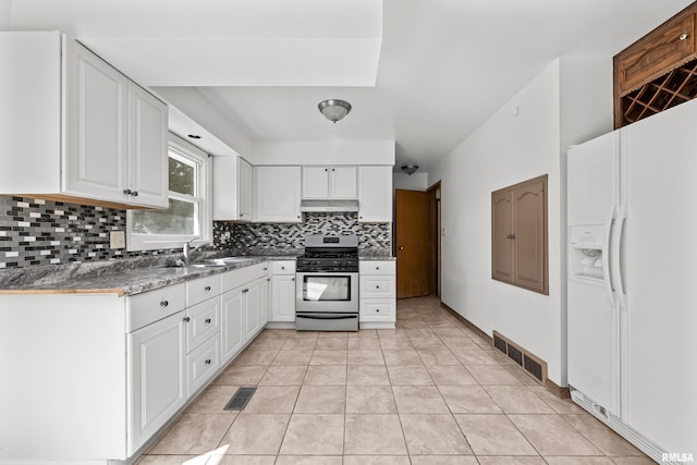 2525 4th St Unit A, East Moline, IL 61244 - kitchen with white refrigerator with ice dispenser, gas range, backsplash, under cabinet range hood, and white cabinets