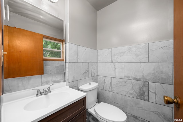 2525 4th St Unit A, East Moline, IL 61244 - bathroom with tile walls, vanity, and a wainscoted wall