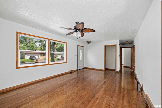 2525 4th St Unit A, East Moline, IL 61244 - unfurnished room featuring wood finished floors, a textured ceiling, and a ceiling fan