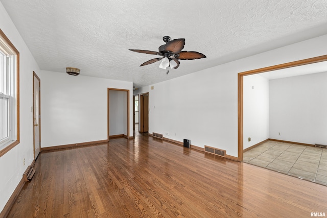 2525 4th St Unit A, East Moline, IL 61244 - unfurnished room featuring ceiling fan, wood finished floors, and a textured ceiling