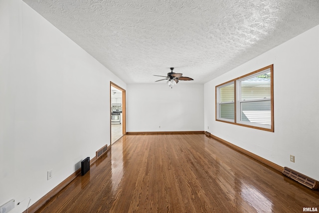 2525 4th St Unit A, East Moline, IL 61244 - unfurnished room with wood finished floors, a ceiling fan, and a textured ceiling