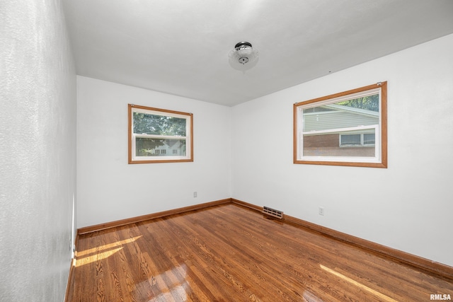 2525 4th St Unit A, East Moline, IL 61244 - spare room with wood finished floors and baseboards