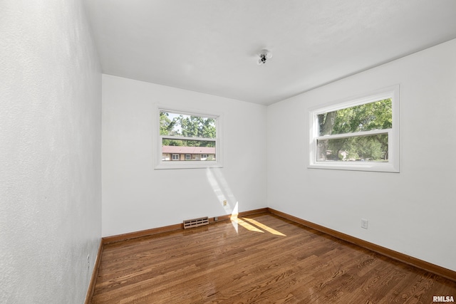 2525 4th St Unit A, East Moline, IL 61244 - spare room featuring baseboards and wood finished floors