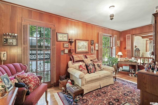1928 Fernwood Ave, Davenport, IA 52803 - living area featuring wood walls, light wood-type flooring, and ornamental molding