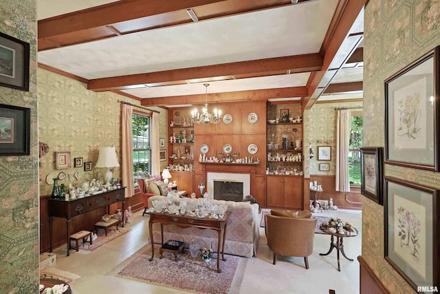 1928 Fernwood Ave, Davenport, IA 52803 - living room featuring a fireplace, beam ceiling, wallpapered walls, a chandelier, and crown molding