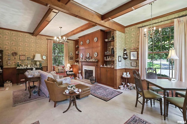 1928 Fernwood Ave, Davenport, IA 52803 - living room featuring a chandelier, wallpapered walls, beam ceiling, a wainscoted wall, and a glass covered fireplace