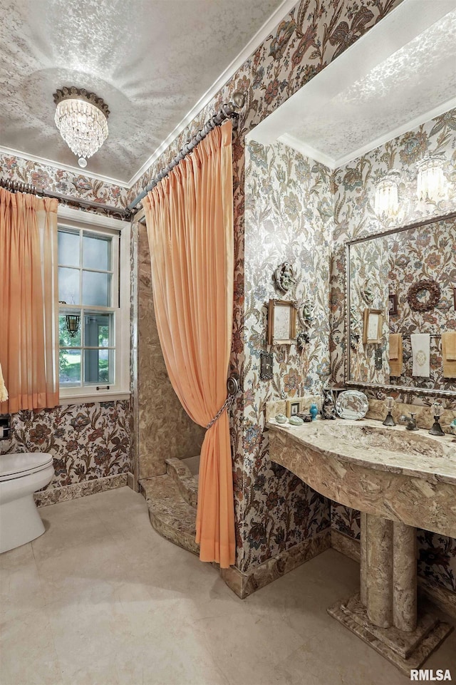 1928 Fernwood Ave, Davenport, IA 52803 - bathroom with wallpapered walls, a chandelier, and crown molding