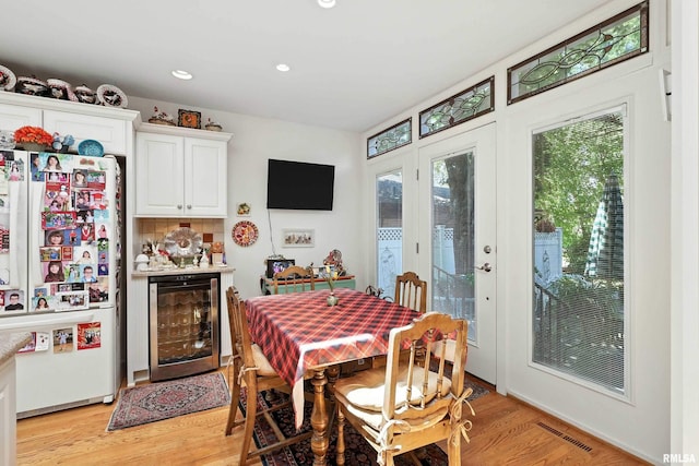 1928 Fernwood Ave, Davenport, IA 52803 - dining space featuring wine cooler, light wood-style flooring, and recessed lighting