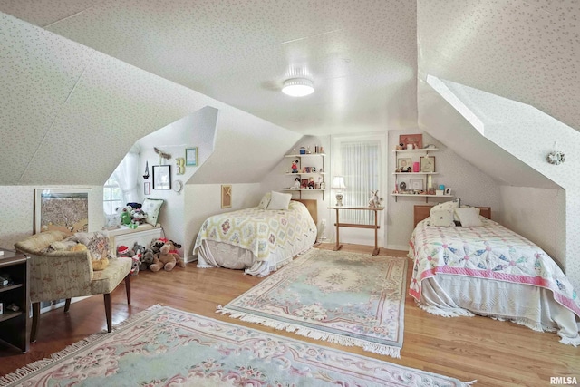1928 Fernwood Ave, Davenport, IA 52803 - bedroom with wood finished floors, vaulted ceiling, and wallpapered walls