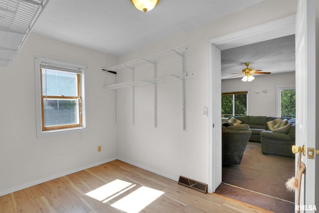 304 E Plum St, Anamosa, IA 52205 - walk in closet featuring light wood-style floors and ceiling fan