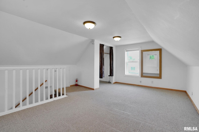 304 E Plum St, Anamosa, IA 52205 - additional living space with lofted ceiling and carpet flooring