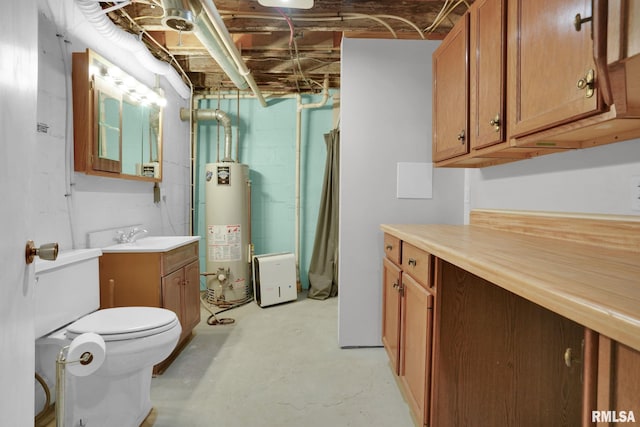 304 E Plum St, Anamosa, IA 52205 - full bathroom with gas water heater, concrete floors, vanity, and concrete block wall