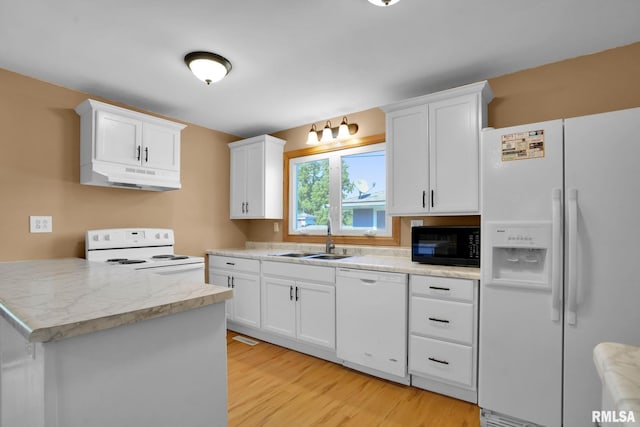 304 E Plum St, Anamosa, IA 52205 - kitchen featuring white appliances, under cabinet range hood, light wood-style floors, and white cabinetry