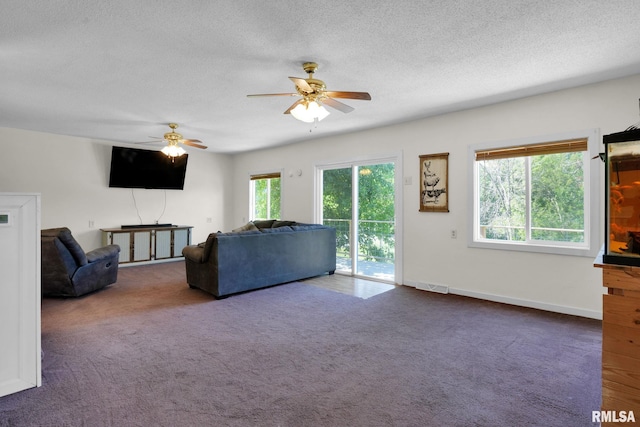 304 E Plum St, Anamosa, IA 52205 - unfurnished living room featuring ceiling fan, carpet flooring, and a textured ceiling