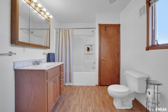 304 E Plum St, Anamosa, IA 52205 - full bathroom with vanity, wood finished floors, and shower / bathtub combination with curtain
