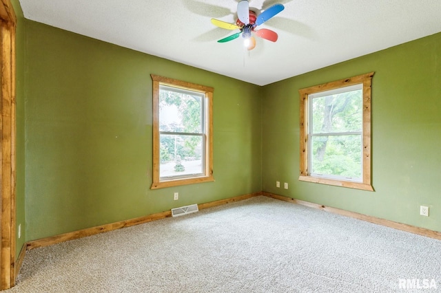 335 Sand Aly, Toronto, IA 52777 - carpeted empty room featuring plenty of natural light and ceiling fan