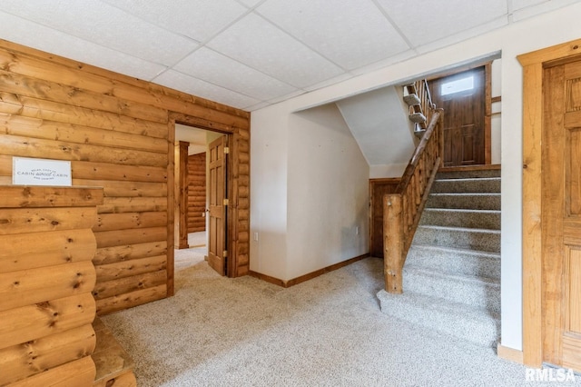335 Sand Aly, Toronto, IA 52777 - stairs with carpet flooring, rustic walls, and a drop ceiling