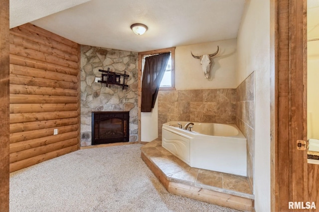 335 Sand Aly, Toronto, IA 52777 - bathroom featuring rustic walls, a bath, and a fireplace