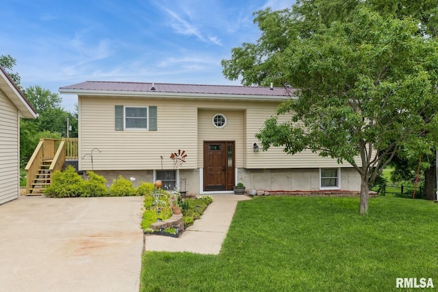335 Sand Aly, Toronto, IA 52777 - split foyer home featuring a front lawn, a metal roof, stairs, and a wooden deck