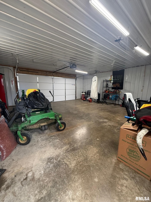 335 Sand Aly, Toronto, IA 52777 - garage featuring a garage door opener