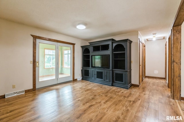 335 Sand Aly, Toronto, IA 52777 - unfurnished living room with light wood-style flooring