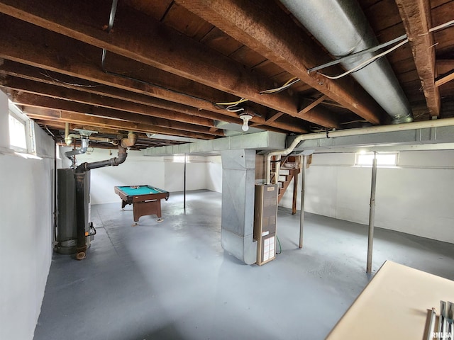 1908 24th St, Moline, IL 61265 - below grade area featuring heating unit, gas water heater, billiards, and stairway