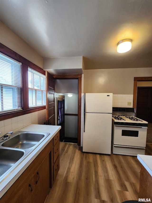 1908 24th St, Moline, IL 61265 - kitchen with white appliances, decorative backsplash, wood finished floors, and light countertops