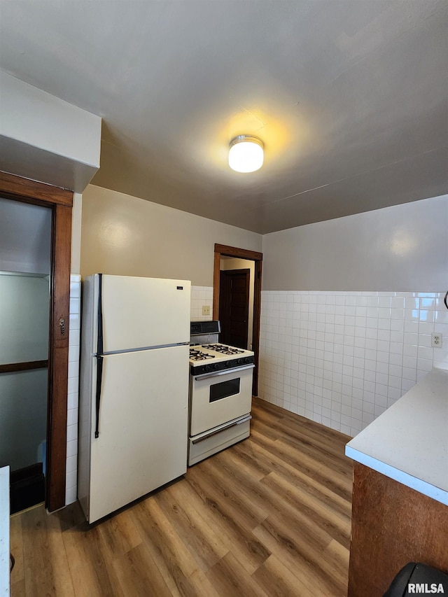 1908 24th St, Moline, IL 61265 - kitchen featuring white appliances, light wood finished floors, and tile walls