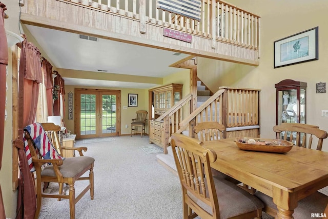 18599 317th St, Long Grove, IA 52756 - dining area with carpet, stairway, a high ceiling, and french doors