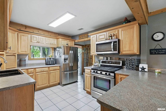 18599 317th St, Long Grove, IA 52756 - kitchen featuring appliances with stainless steel finishes, light tile patterned flooring, and light brown cabinetry