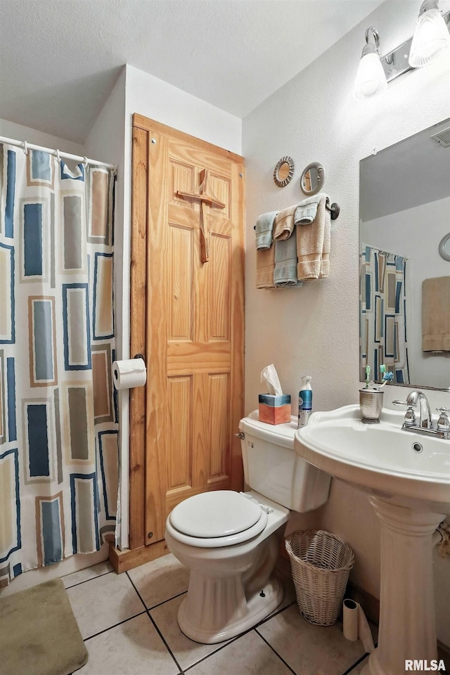 18599 317th St, Long Grove, IA 52756 - bathroom with a shower with curtain, tile patterned floors, a textured wall, and a textured ceiling