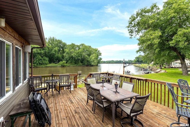 18599 317th St, Long Grove, IA 52756 - deck with outdoor dining area, a water view, and a lawn