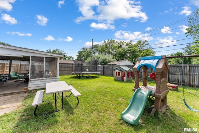 2506 Holly Dr, Bettendorf, IA 52722 - fenced backyard with a trampoline, a playground, and a sunroom