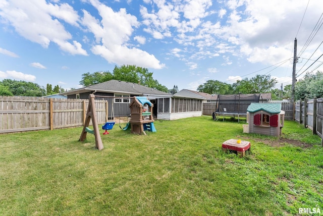 2506 Holly Dr, Bettendorf, IA 52722 - fenced backyard featuring a trampoline, a playground, and a sunroom