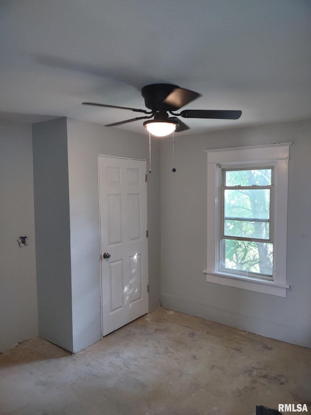 1319 Warren St, Davenport, IA 52804 - spare room featuring concrete flooring and a ceiling fan