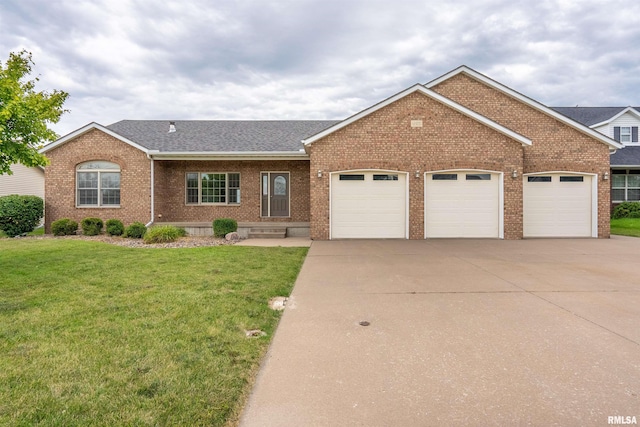 922 W Scott St, Eldridge, IA 52748 - view of front facade featuring brick siding, an attached garage, concrete driveway, a front lawn, and roof with shingles