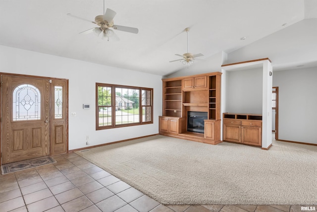 922 W Scott St, Eldridge, IA 52748 - unfurnished living room with vaulted ceiling, a ceiling fan, light carpet, and light tile patterned floors